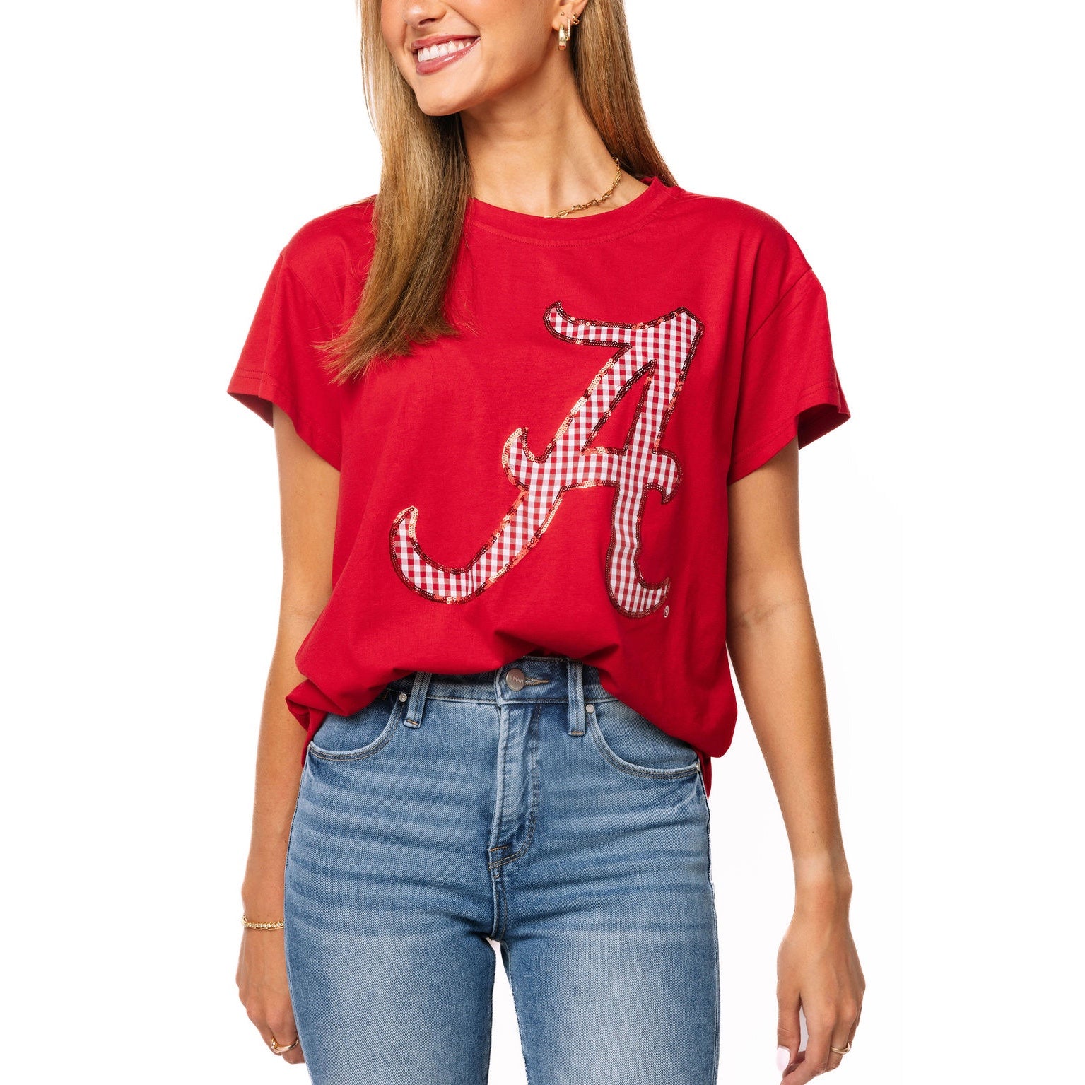 Person wearing a red t-shirt with a large letter 'A' design on a white background