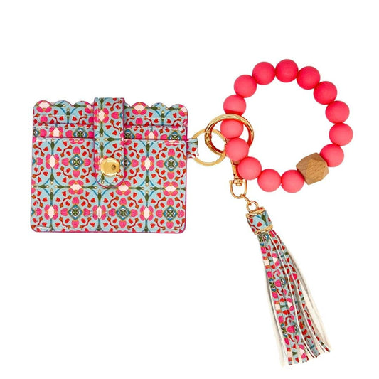 Floral patterned cardholder with pink beaded keychain on a white background