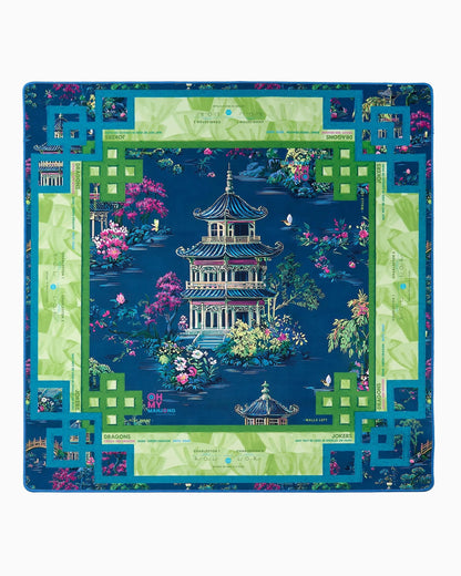 Colorful board game mat with a pagoda design on a blue background