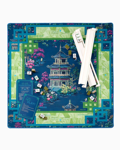 Board game set with colorful board, pieces, and cards on a white background