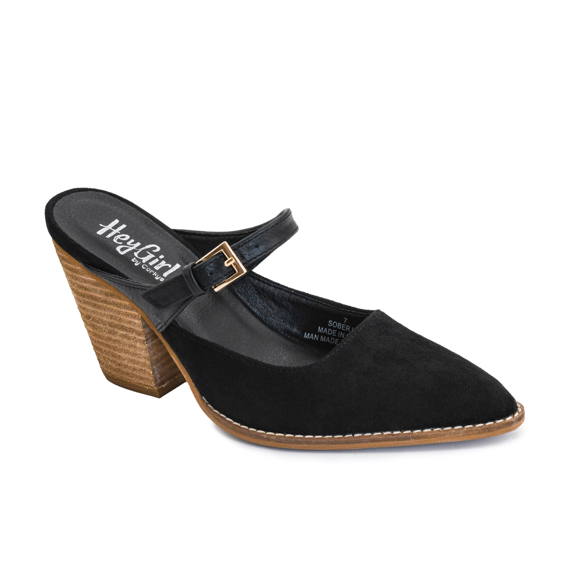 A black suede mule sandal with a pointed toe, a low block heel with a textured tan base, and a gold buckle strap, shown on a white background. The brand 'HeyGirl' is visible on the insole.