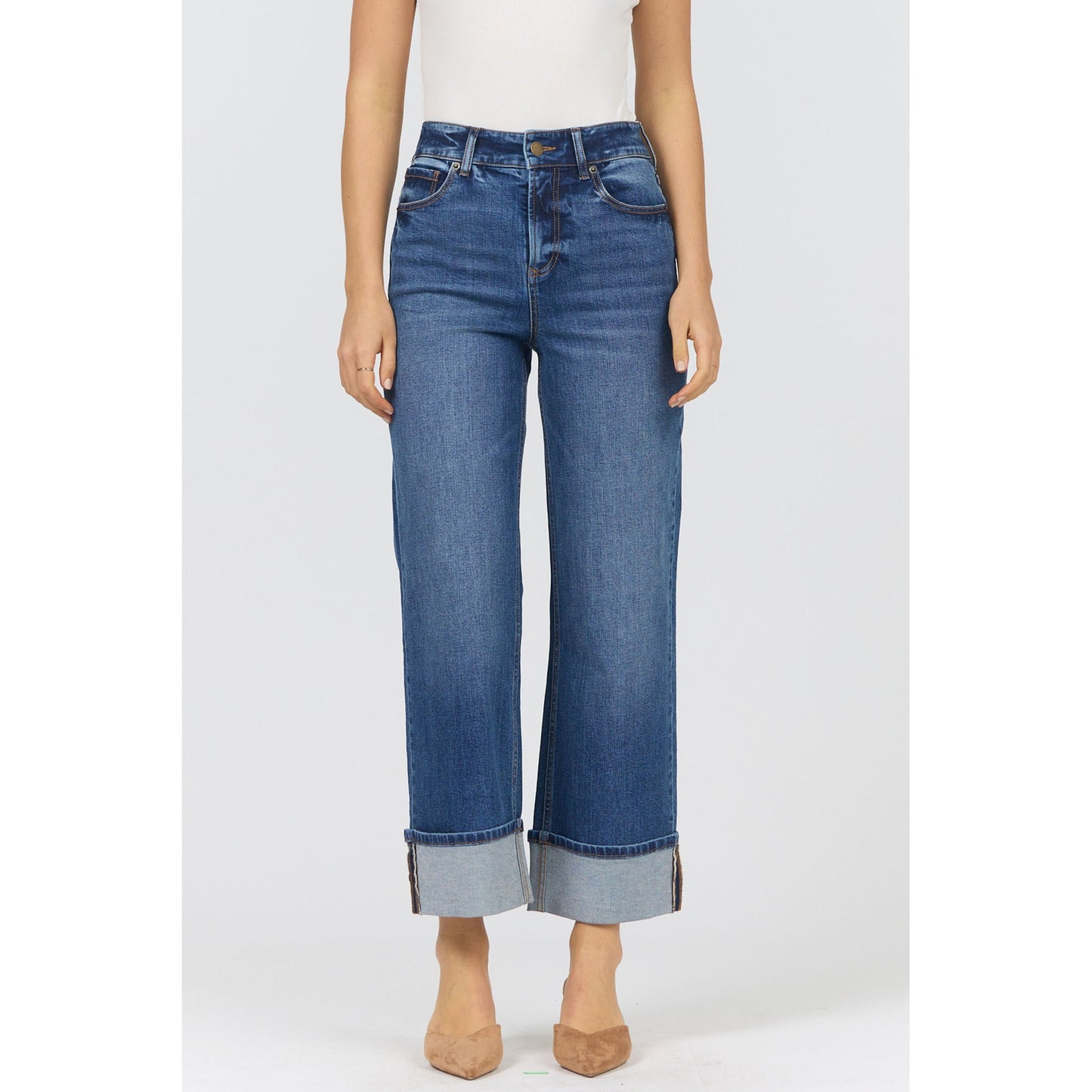 Blue jeans worn by a person on a white background